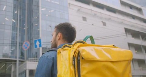 Closeup back view portrait of bearded caucasian delivery man with backpack Stock Footage 114820453
