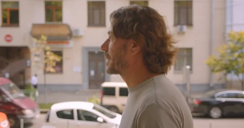 Closeup back view portrait of handsome caucasian man walking in park outdoors Stock Footage 114917294