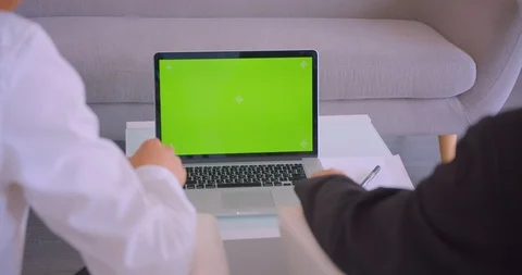 Closeup back view portrait of two businessmen using laptop with green screen and Video stock 114005067