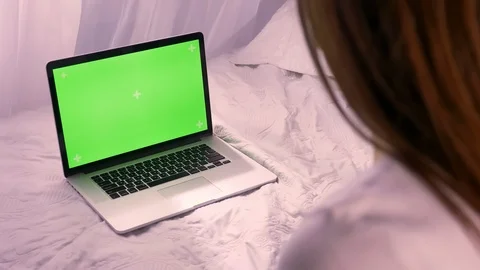 Closeup back view of young caucasian female having a laptop with green chroma Stock Footage 102041537