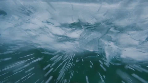 Closeup background of cracks and bubbles in transparent ice. blurred foreground. Stock Footage 230463341