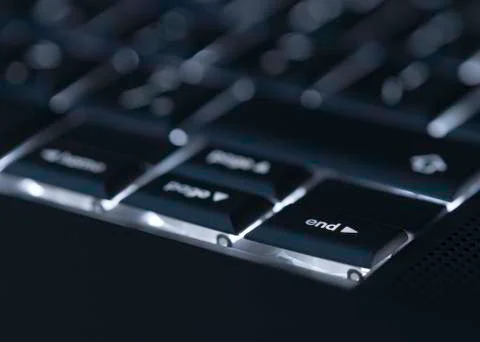 Closeup of backlit computer laptop keyboard selective focus on end key ideal Stock-Fotos