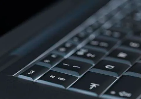 Closeup of backlit computer laptop keyboard selective focus on escape key ide Stock-Fotos