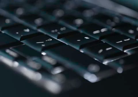 Closeup of backlit computer laptop keyboard selective focus on question mark Stock-Fotos