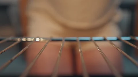 Closeup of baker in kitchen. Preparing oven rack with linen apron nearby Video stock 345537577