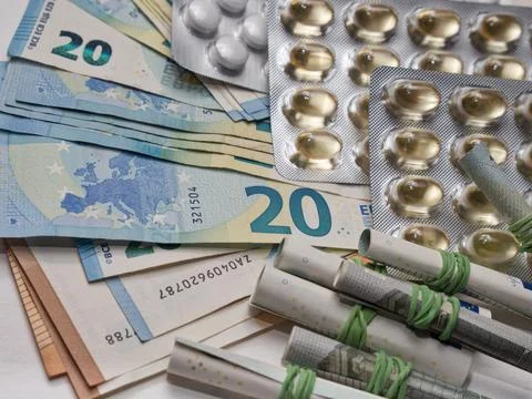 A closeup of banknotes and tablets symbolizing the costs of the healthcare .. 스톡 사진