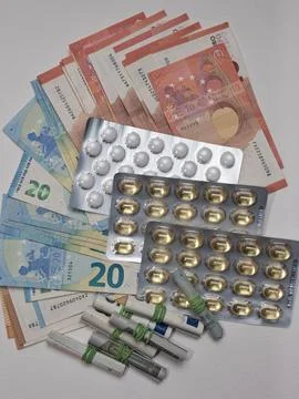 A closeup of banknotes and tablets symbolizing the costs of the healthcare .. 스톡 사진