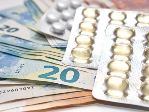 A closeup of banknotes and tablets symbolizing the costs of the healthcare .. 스톡 사진