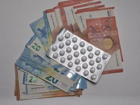 A closeup of banknotes and tablets symbolizing the costs of the healthcare .. 스톡 사진