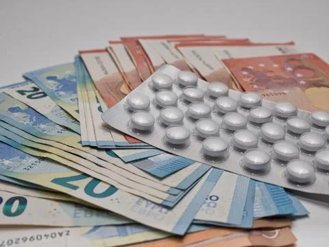 A closeup of banknotes and tablets symbolizing the costs of the healthcare .. Stock-Fotos