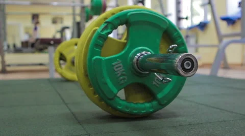 Closeup barbell plates on the floor Stock Footage 58599569