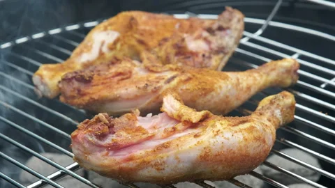 Closeup of barbeque with three spiced chicken legs Stock Footage 200826356
