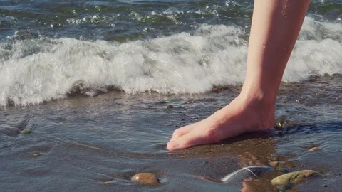 Closeup of bare feet on the beach. Stock Footage 124756810