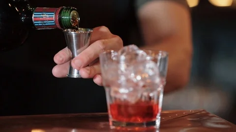Closeup of bartender hand preparing blackberry smoothie with grapefruit. He Stock Footage 125993067