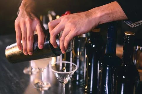 Closeup bartender hand preparing fresh juice cocktail in drinking wine glas.. Stock Photos