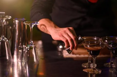Closeup bartender hand preparing fresh juice cocktail in drinking wine glas.. Photos