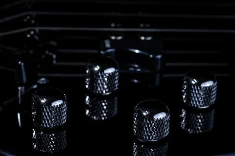 Closeup of bass guitar knobs and strings Stock Photos