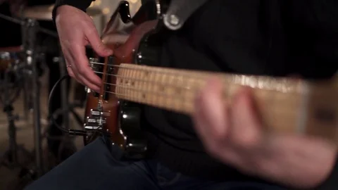CloseUp of Bass Player Hands Playing Rock Music with Bass Guitar at the Concert Stock Footage 85391836