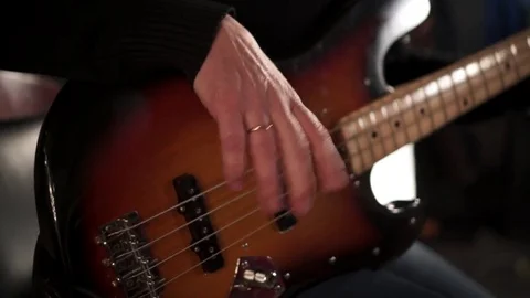 CloseUp of Bass Player Hands Playing Rock Music with Bass Guitar at the Concert  Video stock 85391844