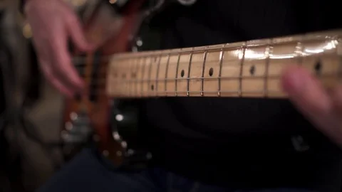 CloseUp of Bass Player Hands Playing Rock Music with Bass Guitar at the Concert  Stock Footage 85391845
