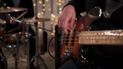 CloseUp of Bass Player Hands Playing Rock Music with Bass Guitar at the Concert  Stock Footage 85391848