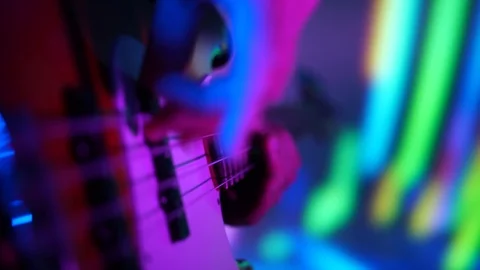 Closeup of bass player hands playing fast music with bass guitar at the concert Stock Footage 99691656