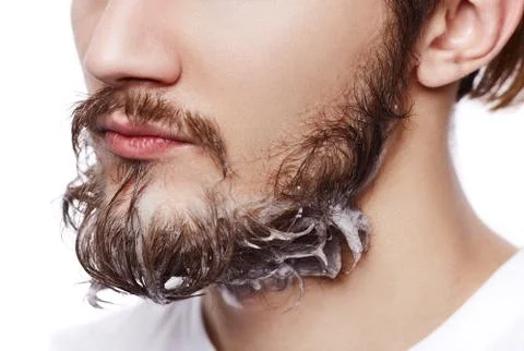 Closeup of beard man with soap on face isolated on white Stockfoto's