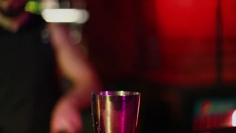 Closeup of a bearded barman preparing a cocktail at the night club. Stock Footage 103381841