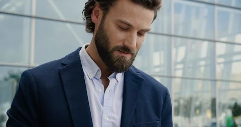 Closeup of Bearded Businessman is using his Smartphone while texting Messages Stock Footage 117688358
