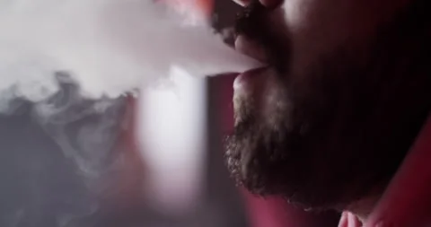 Closeup bearded guy smoking hookah in bar Stock Footage 229484542
