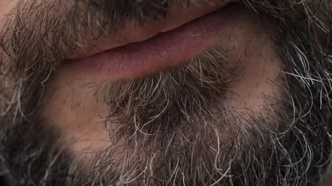 A closeup of a bearded man using a heated tobacco device Vidéo 288380728