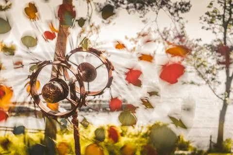 A Closeup Of A Beautiful Copper Sphere Wind Spinner By The Seashore Stock Photos