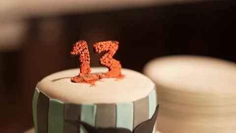 Closeup of a beautiful delicious big cake with thirteen number on top durin.. Stock Footage 313258558