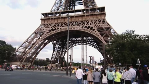 Closeup of the beautiful Eiffel Tower in Paris, France with people standing Stock Footage 158604790