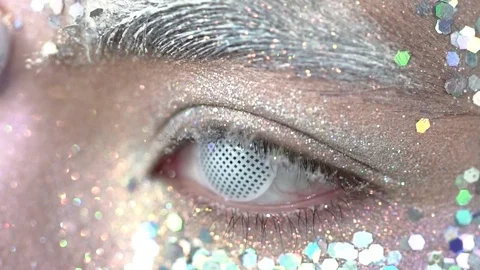 Closeup of beautiful eye with the white glitter makeup blinking slow motion Stock Footage 75969982
