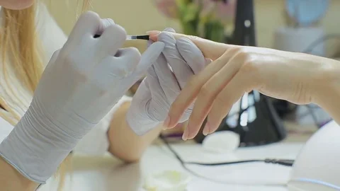 Closeup Of Beautiful Female Hands Applying Transparent Nail Polish On Nails Stock Footage
