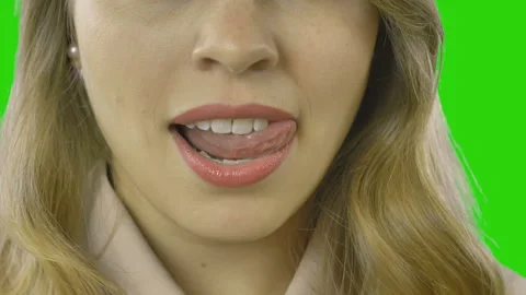 Closeup of beautiful plump lips of a young girl showing tongue and white teeth Stock Footage 99480072