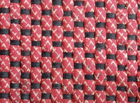 A closeup of a beautiful red vertical thread pattern with black and white sma Foto stock