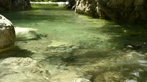 Closeup of a beautiful stream in the mountains with very clear and clean water Stock Footage 211488592