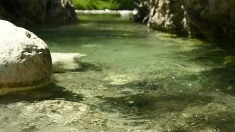 Closeup of a beautiful stream in the mountains with very clear and clean water Stock Footage 211488610