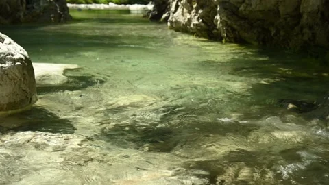 Closeup of a beautiful stream in the mountains with very clear and clean water Stock Footage 211489194