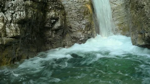 Closeup of a beautiful waterfall in between rocks in the mountains Stock Footage 211496192