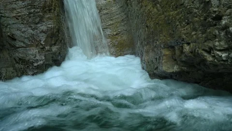 Closeup of a beautiful waterfall in between rocks in the mountains Stock Footage 211497369