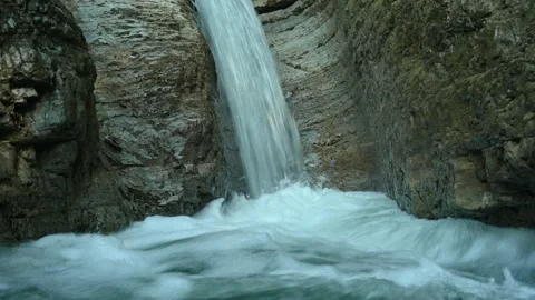 Closeup of a beautiful waterfall in between rocks in the mountains Stock Footage 211497494