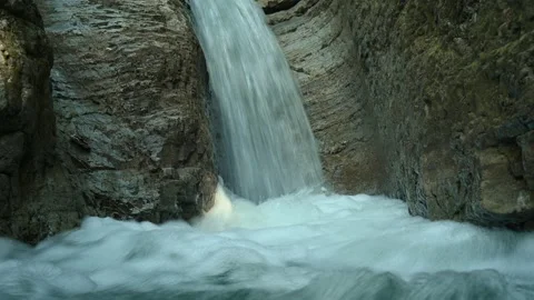 Closeup of a beautiful waterfall in between rocks in the mountains Stock-Footage 211498256