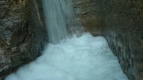 Closeup of a beautiful waterfall in between rocks in the mountains Stock Footage 211499275