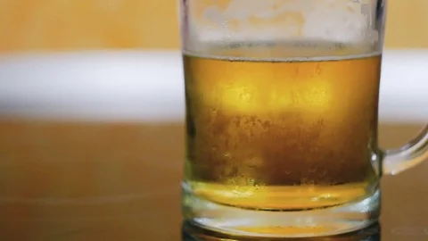 Closeup of a beer glass half full of beer Stock Footage 80231381