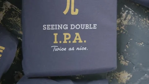 Closeup of Beer Style Text on Printed Fabric in Beijing Brewery Environment Stock Footage 345755937