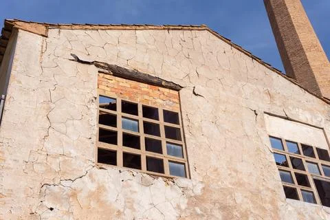 Closeup from below of a windows of an old abandoned gray paper mill with a .. Stock Photos