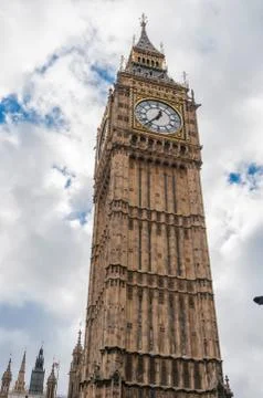 Closeup of big ben clock tower in london against cloudy sky Stock Photos